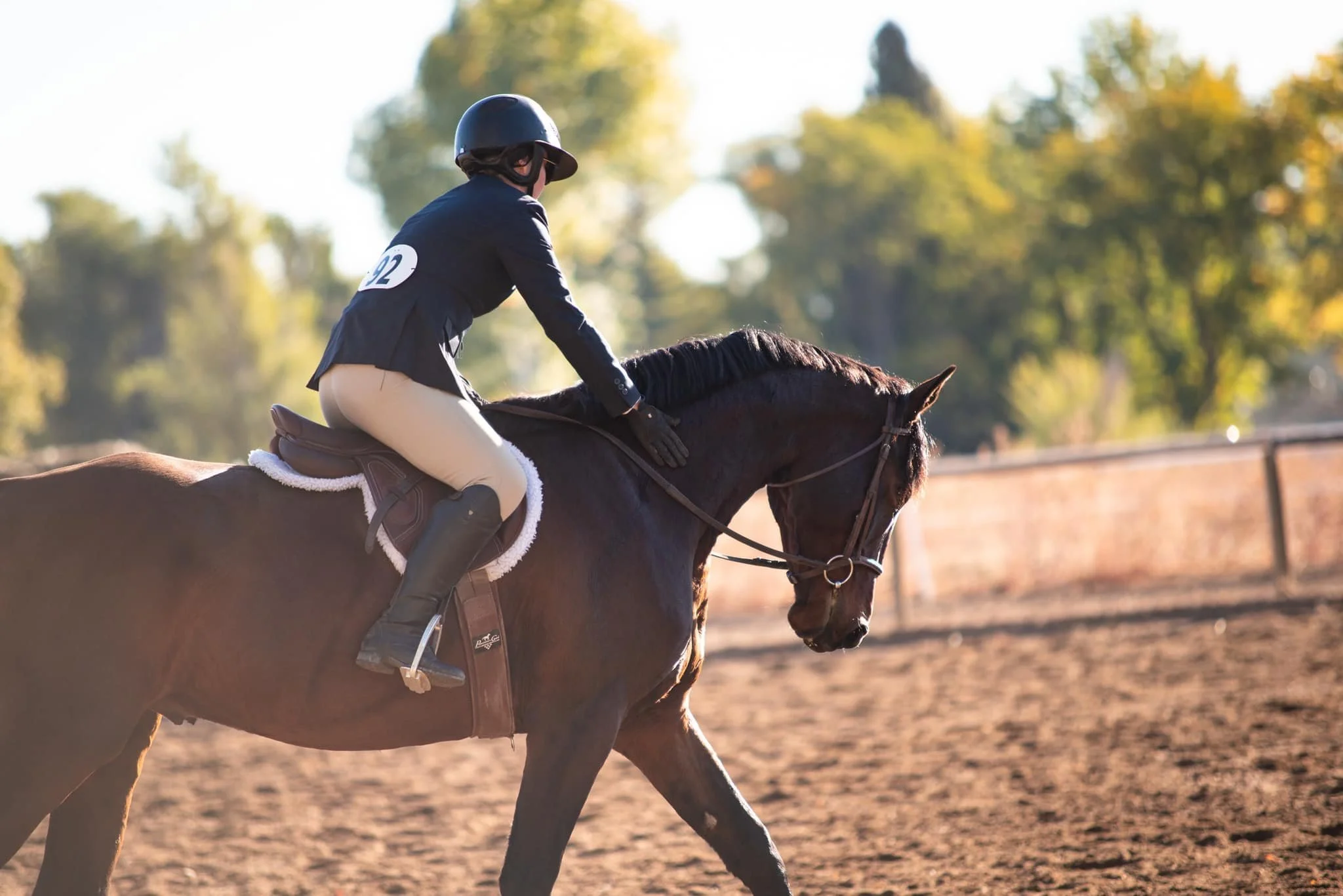 Miranda working with a rider before a class, mountains behind